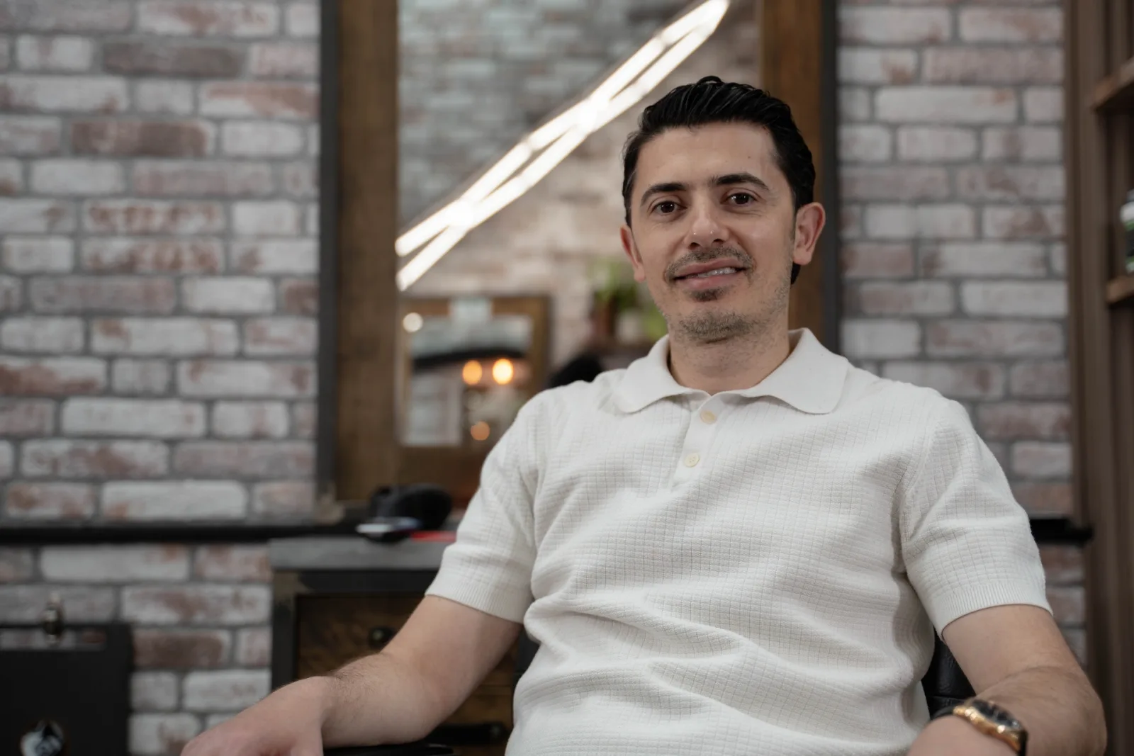 Close-up portrait of Artur Abo Simonov, master barber and owner of Alfani's Barbershop Denver