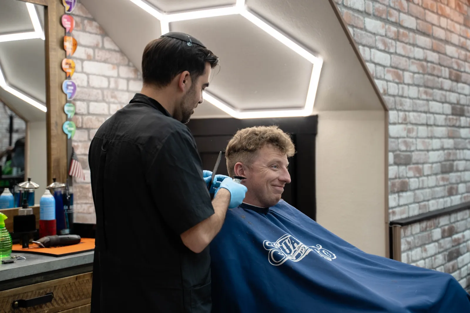 David cleaning up a neckline with clippers at Alfani's Barbershop Denver
