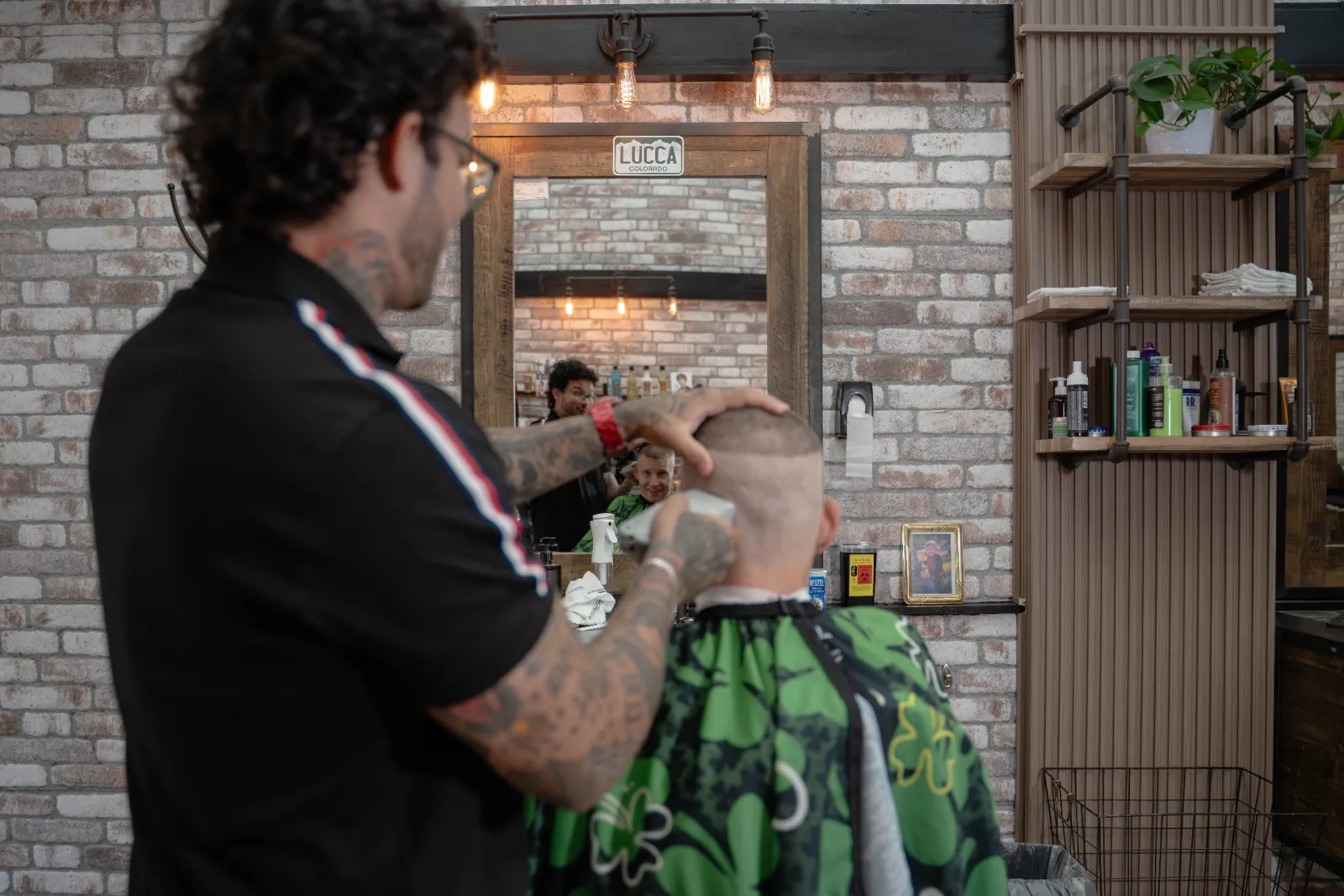Lucca cutting a razor-sharp skin fade with clippers at Alfani's Barbershop Denver