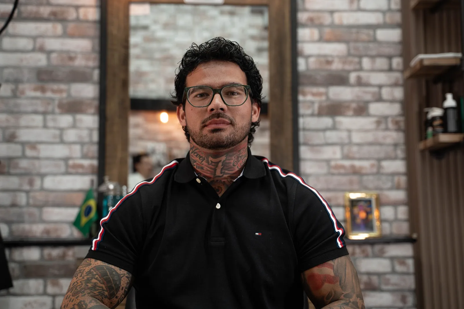 Close-up portrait of Lucca, tattoo artist and barber at Alfani's Barbershop Denver