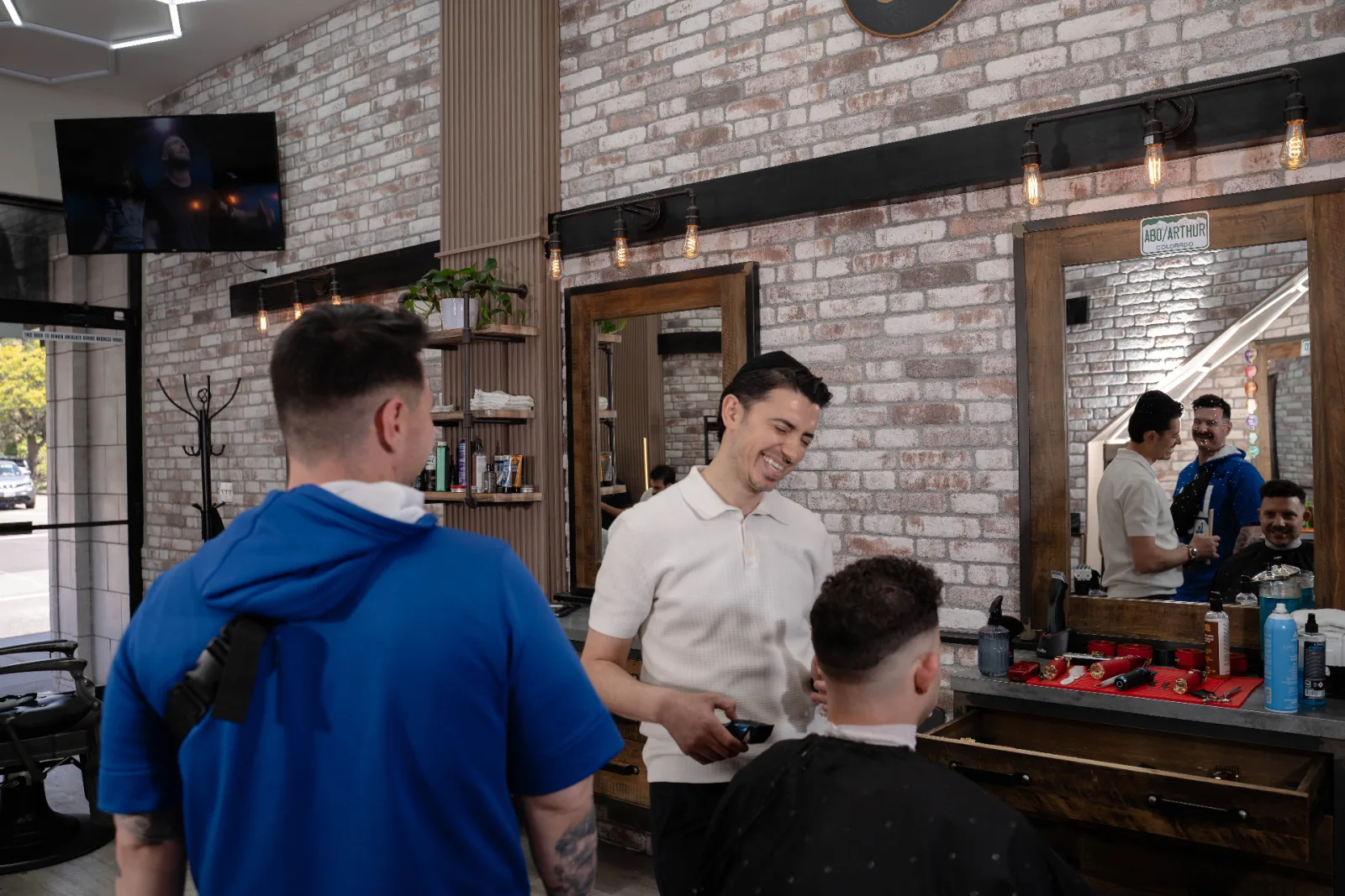 Artur Abo Simonov giving a fresh mid fade at Alfani's Barbershop in Denver