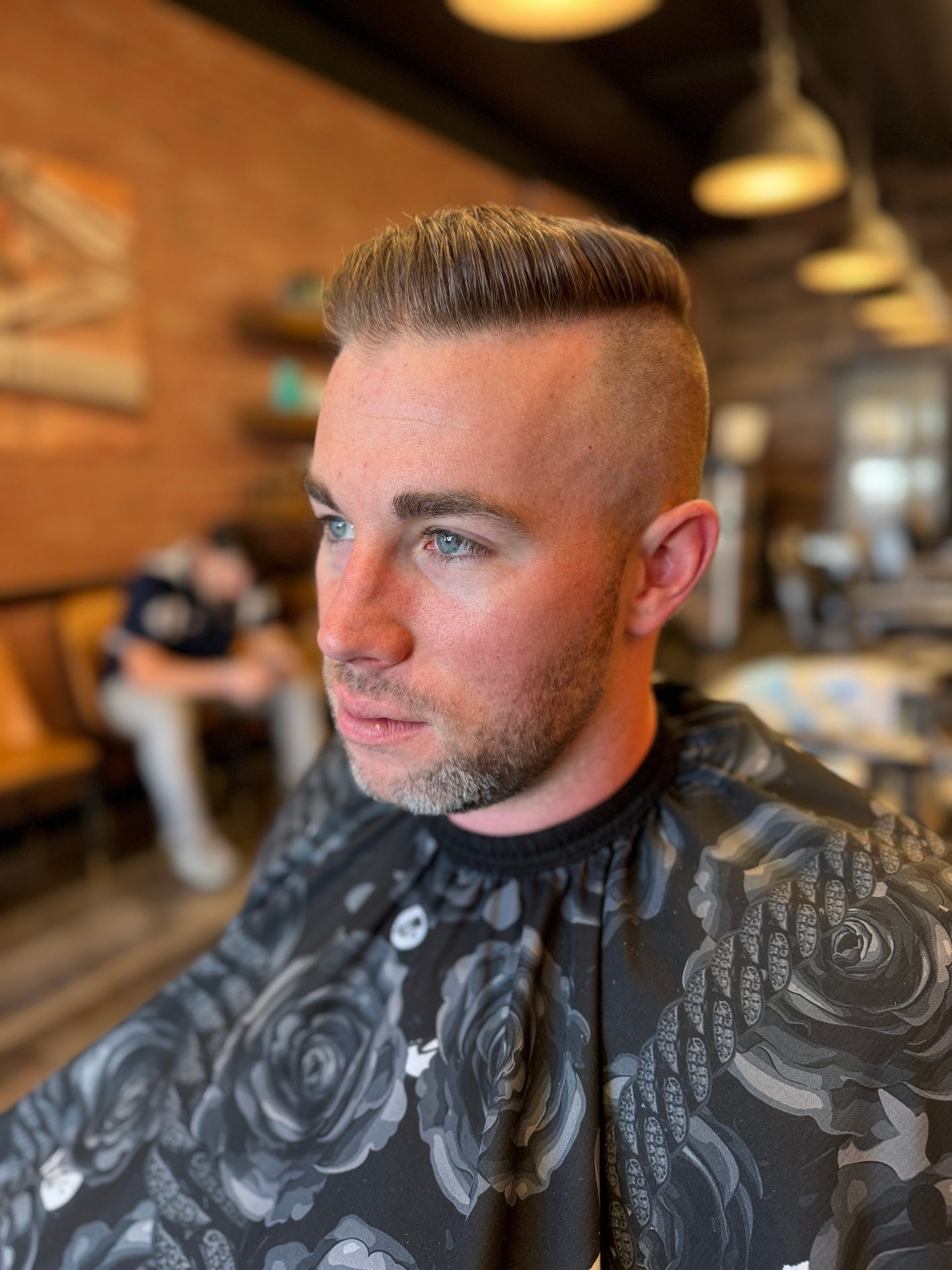 Classic fade haircut with hard part at Alfani's Barbershop Denver
